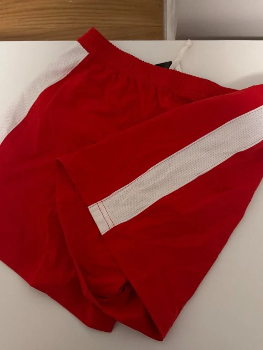 Nike red shorts with white side panels